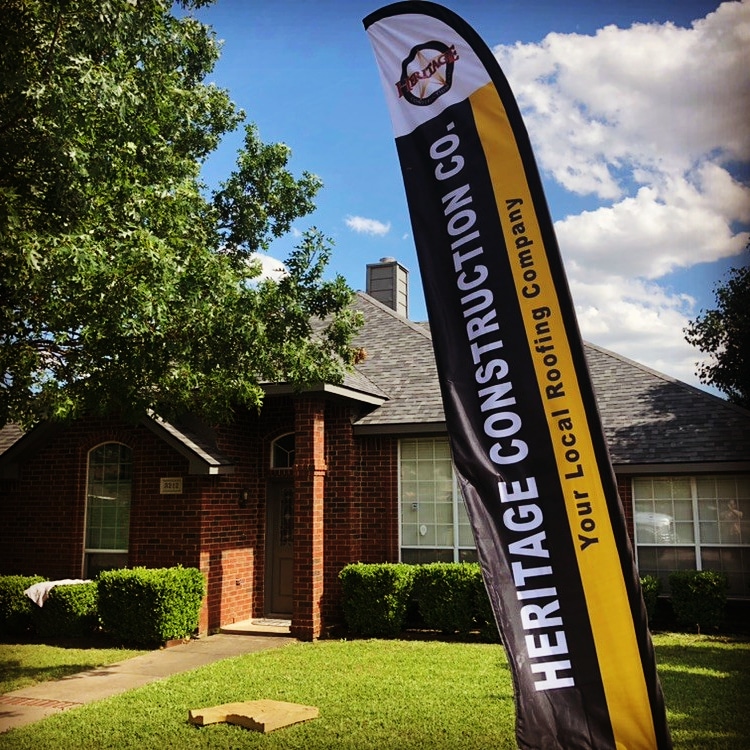 Hickey Construction feather flag in front of a Pennsylvania home mid-install